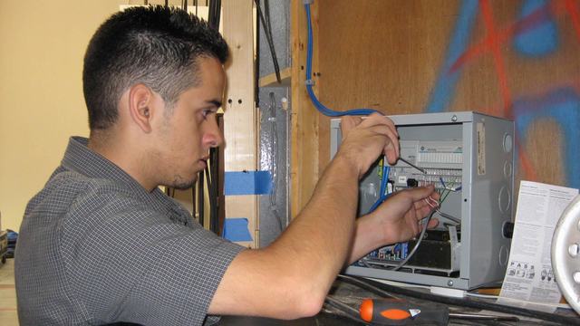 Ben wiring data lines to a game show panel.