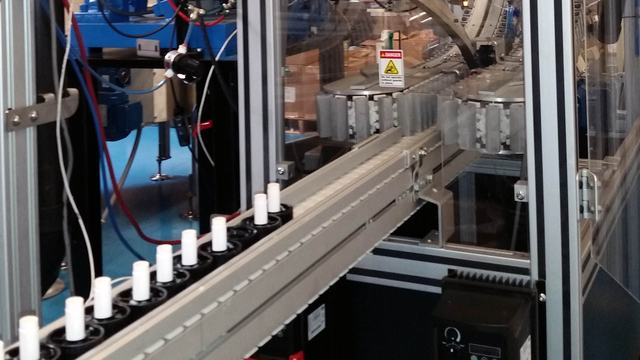 Lip balm taking a ride on a conveyor.